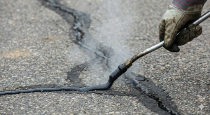 asphalt crack sealing before spring sealcoating Indiana commercial property